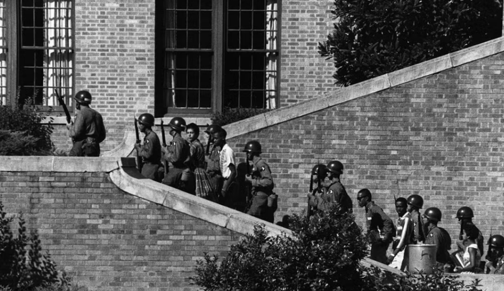 Soldiers escort the Little Rock Nine students into Little Rock Central High School