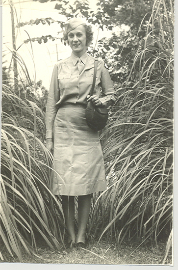 Mabel Edna Grundmeier standing outdoors in a military uniform.