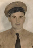 Young serviceman wearing a dark military cap in a colorized portrait.