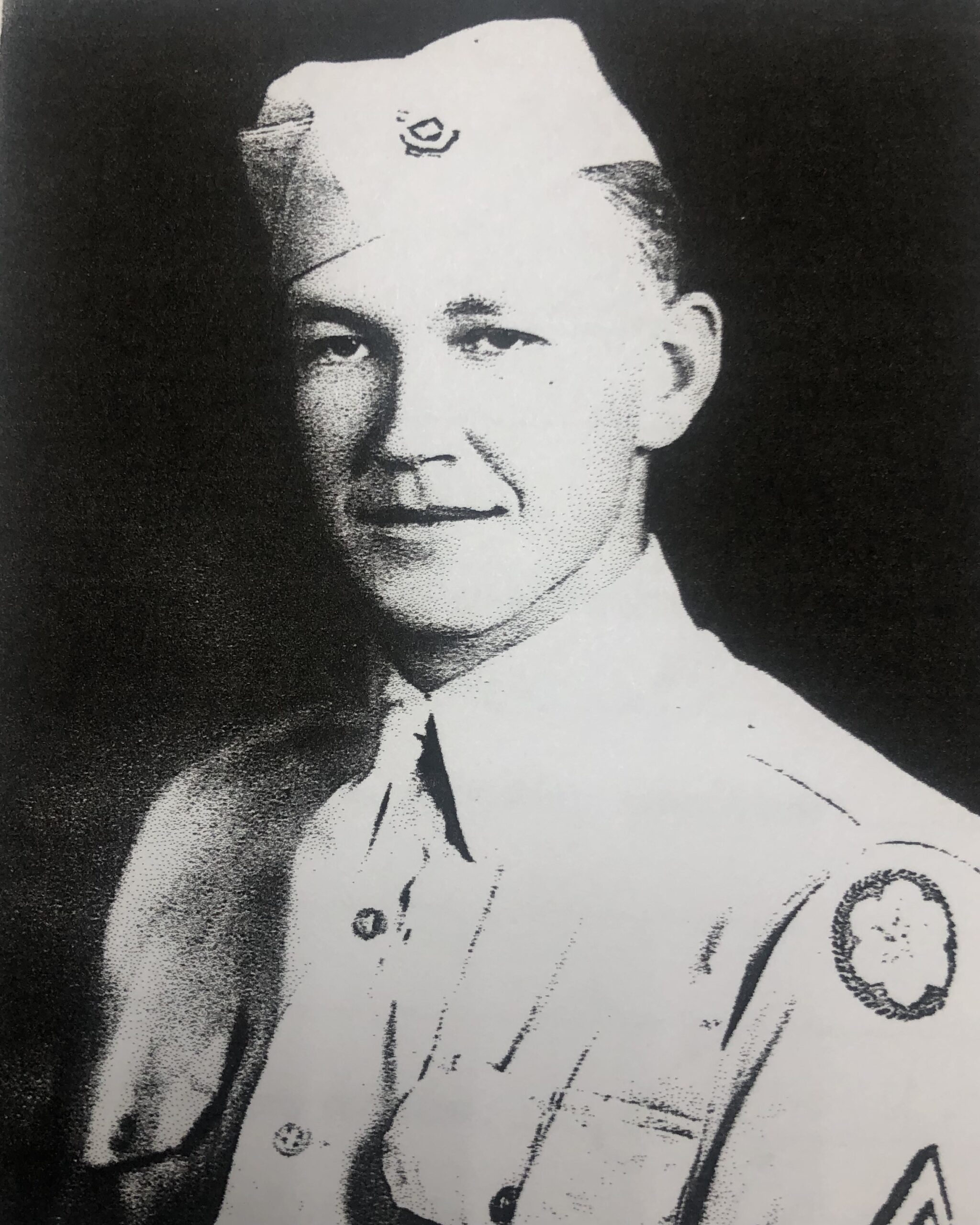 Young serviceman smiling in a formal military portrait.