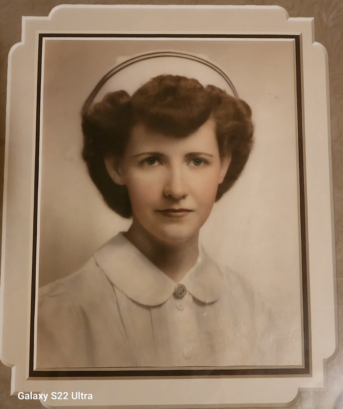 Mary Hoffmann wearing a nurse’s cap in a formal graduation portrait.
