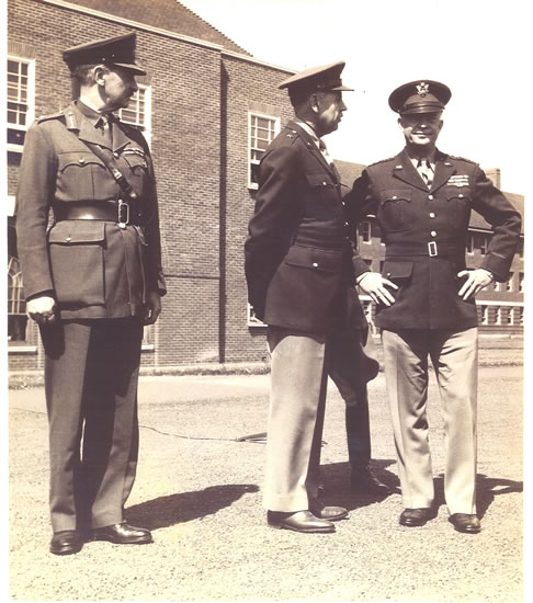 Three military officers standing together outside a building.
