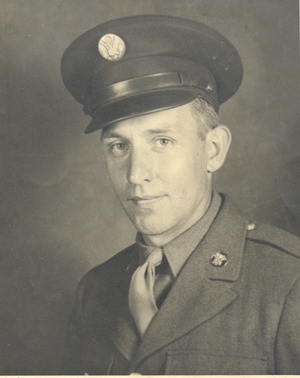 Portrait of a serviceman wearing a military uniform and peaked cap.