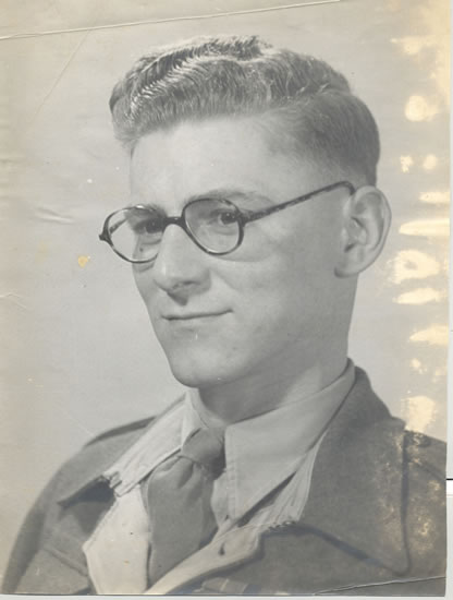 Young man wearing glasses in a formal portrait.