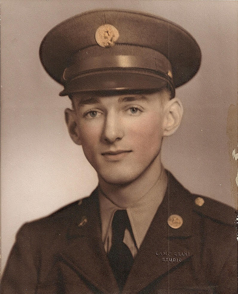 Young serviceman wearing a military uniform and peaked cap.