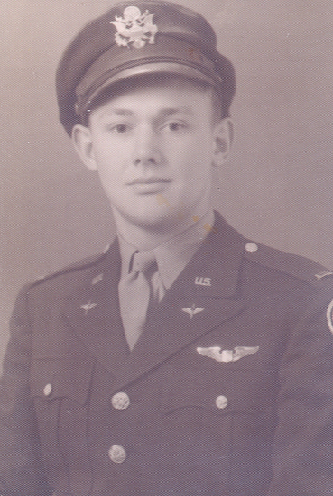 A person in military uniform wearing a tie. They are looking at the camera.