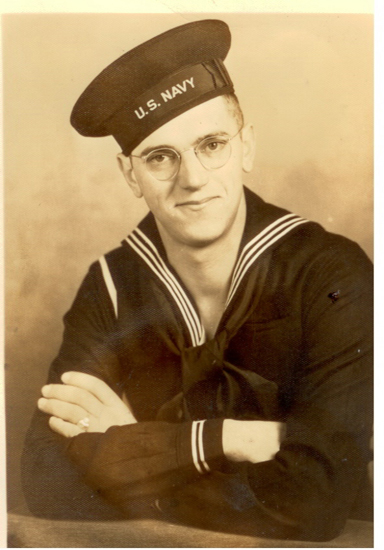 Sailor wearing glasses and a dark U.S. Navy uniform.
