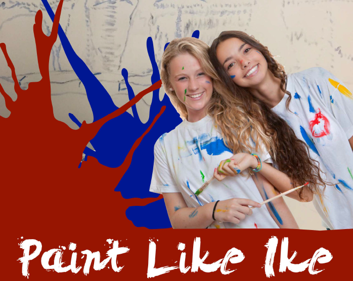 Two women smile together during a Paint Like Ike art activity.
