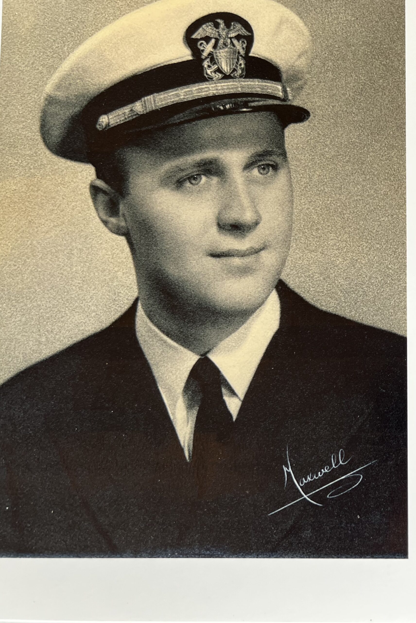 Young serviceman wearing a military dress uniform and peaked cap.