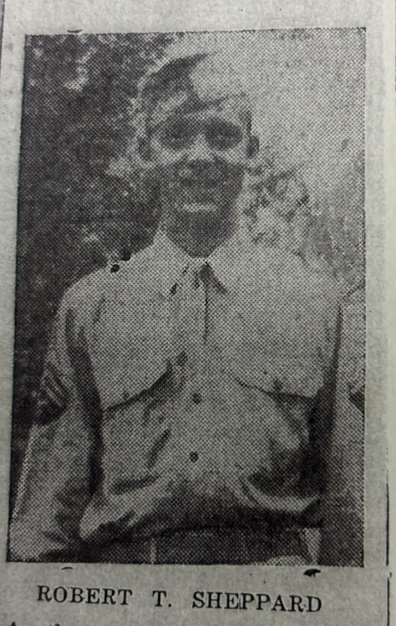 Newspaper cutout of Robert T. Sheppard standing outdoors in a light-colored military uniform.