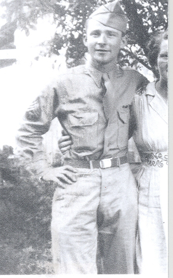 Ralph Leroy Reynolds standing outdoors in a military uniform.