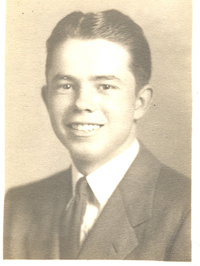 Smiling Raymond Edwin King in a formal portrait.