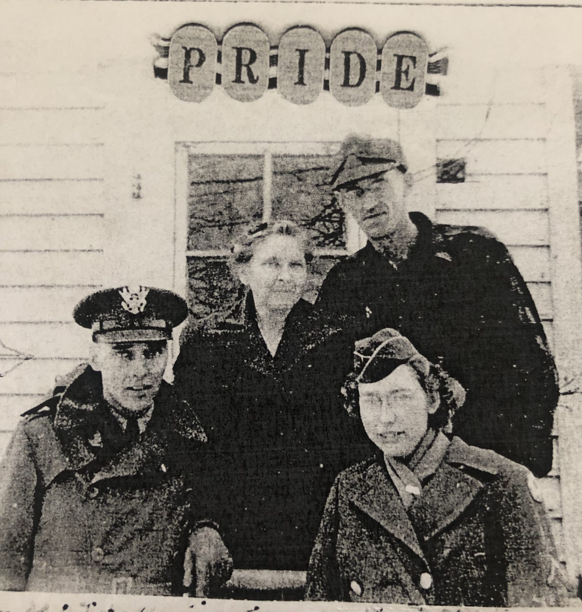 Rex Fenner standing beside an older woman beneath a “Pride” sign.