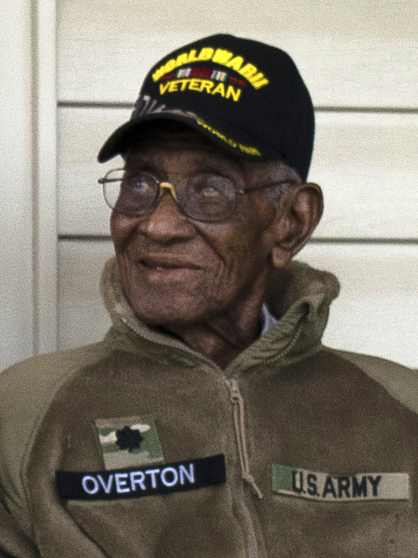 Veteran Richard Overton smiling while wearing a veteran cap.
