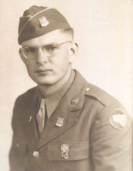 Robert Martin Hohe wearing glasses, a military uniform, and a garrison cap.