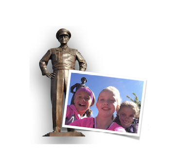 Statue of Dwight D. Eisenhower with children pictured in the foreground.
