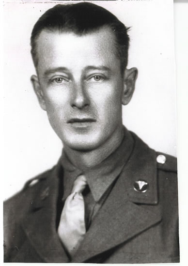 Serviceman wearing a military uniform in a formal portrait.
