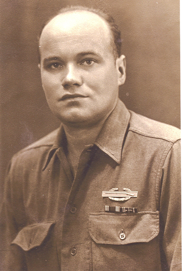 Serviceman wearing a decorated military shirt in a close-up portrait.