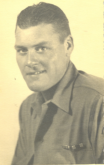 Serviceman Spicer wearing a military shirt in a close-up portrait.