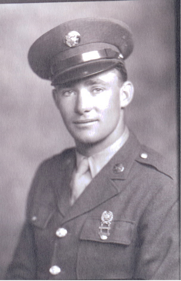 Serviceman wearing a military uniform and peaked cap.