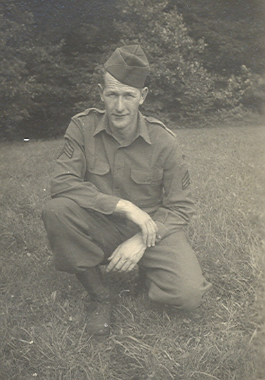 Rex L. Sterling seated outdoors in a military uniform.