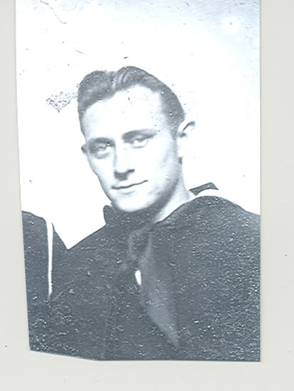 Young sailor wearing a dark naval uniform in a formal portrait.