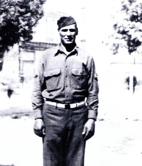 Elmer Louis Stoddard standing outdoors in military uniform.