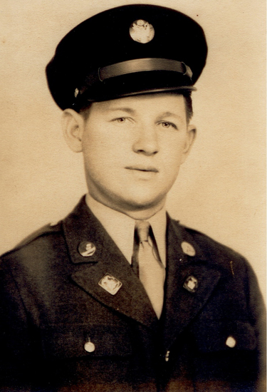 Young serviceman wearing a U.S. Army uniform and peaked cap.