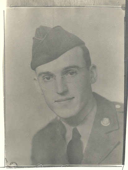 Young serviceman wearing a military uniform and garrison cap.