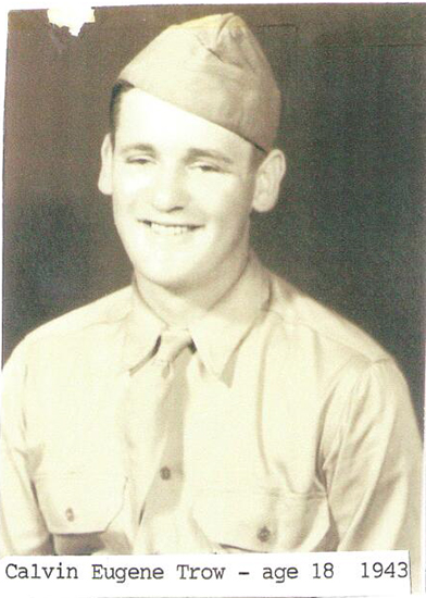 A young man in military uniform smiling at the camera.