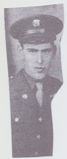 This is an old black and white photograph featuring a man in uniform. He appears to be a soldier, as indicated by his attire that includes a hat with a badge on the side, possibly indicating rank or service branch.