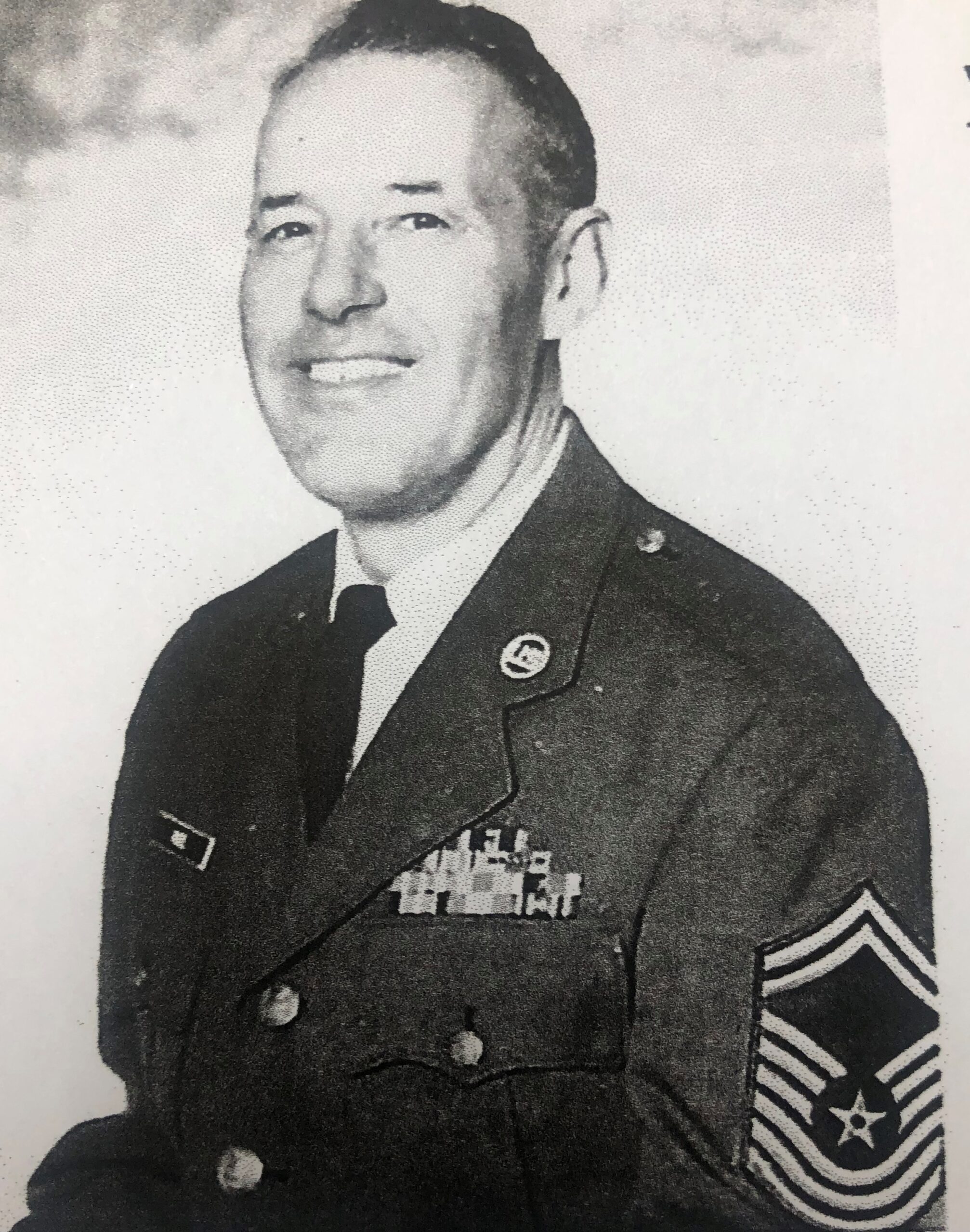 Older serviceman wearing a decorated military dress uniform.