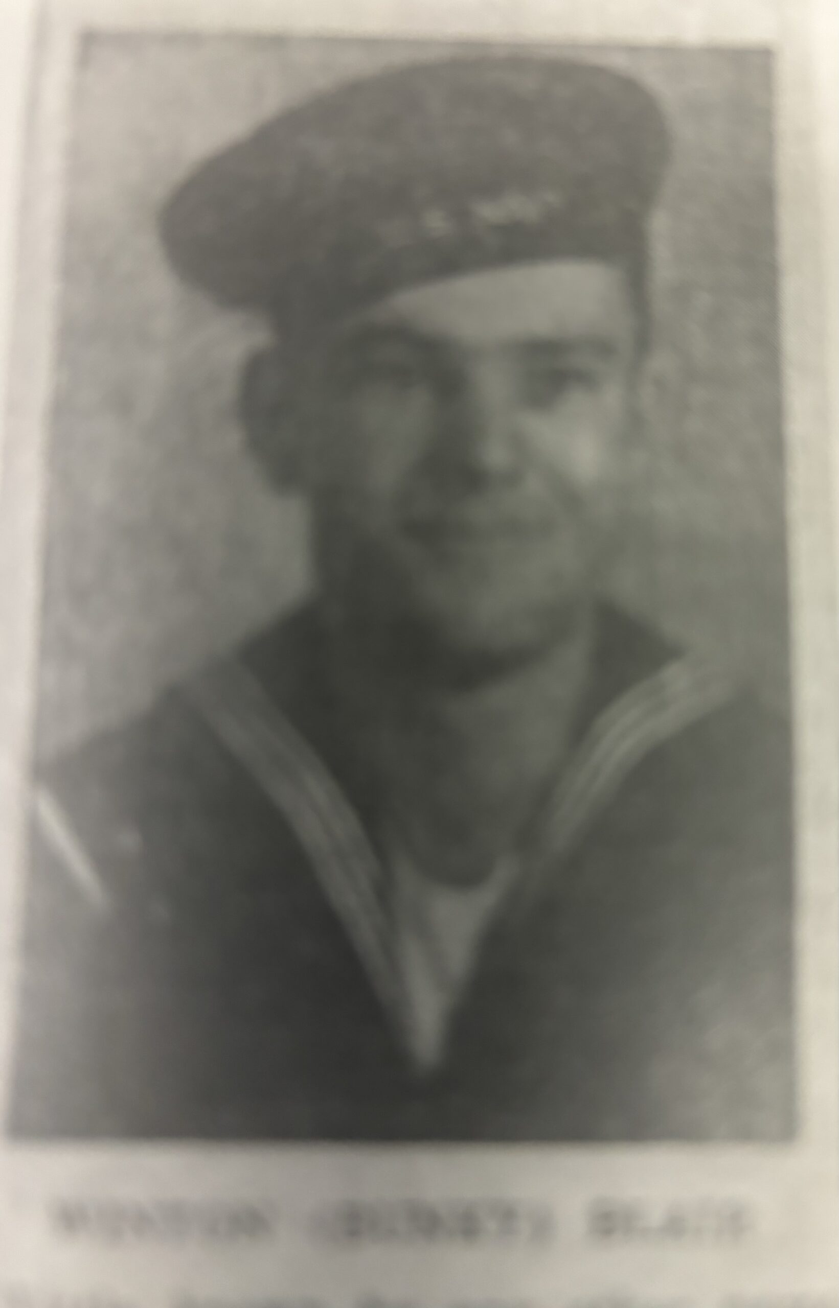 Man in military uniform shown in a faded portrait.