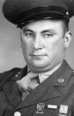 Serviceman wearing a military uniform in a close-up portrait.