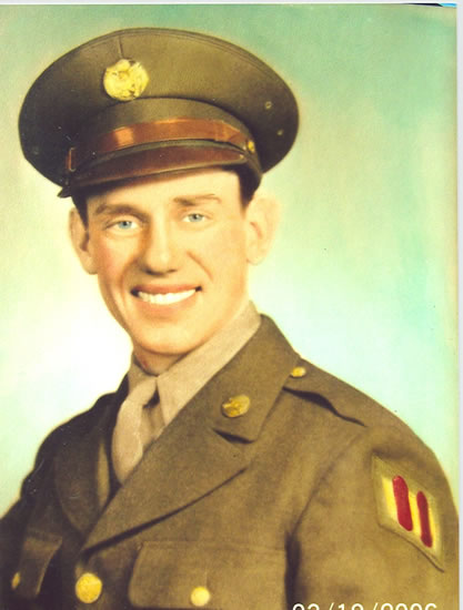 A man in military uniform, smiling at the camera.