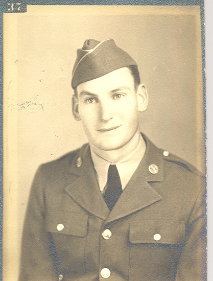 Old black and white photo of a person in military attire.