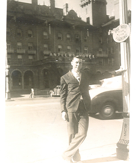 Serviceman standing outdoors on a city street.