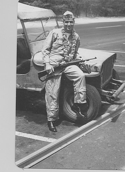 Robert Whitebread seated on a military vehicle in uniform.