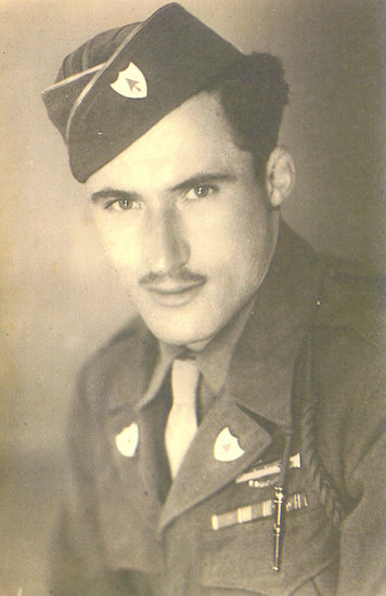 Young serviceman with a mustache wearing a military garrison cap.
