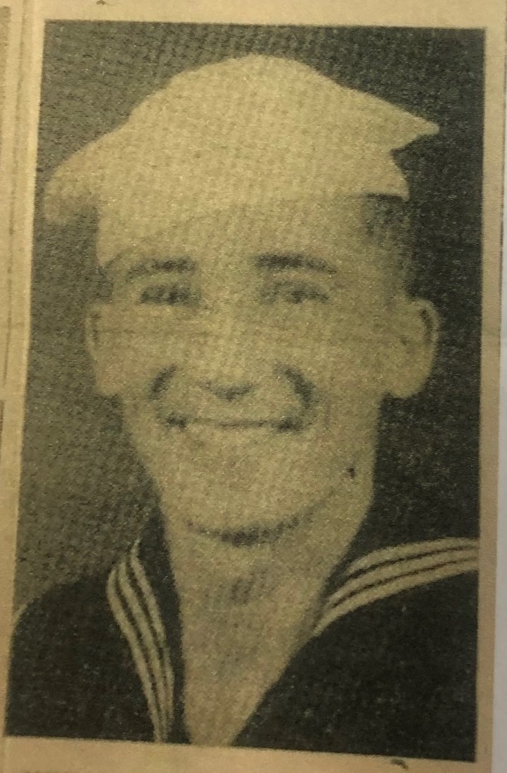Smiling young serviceman in a faded military portrait.
