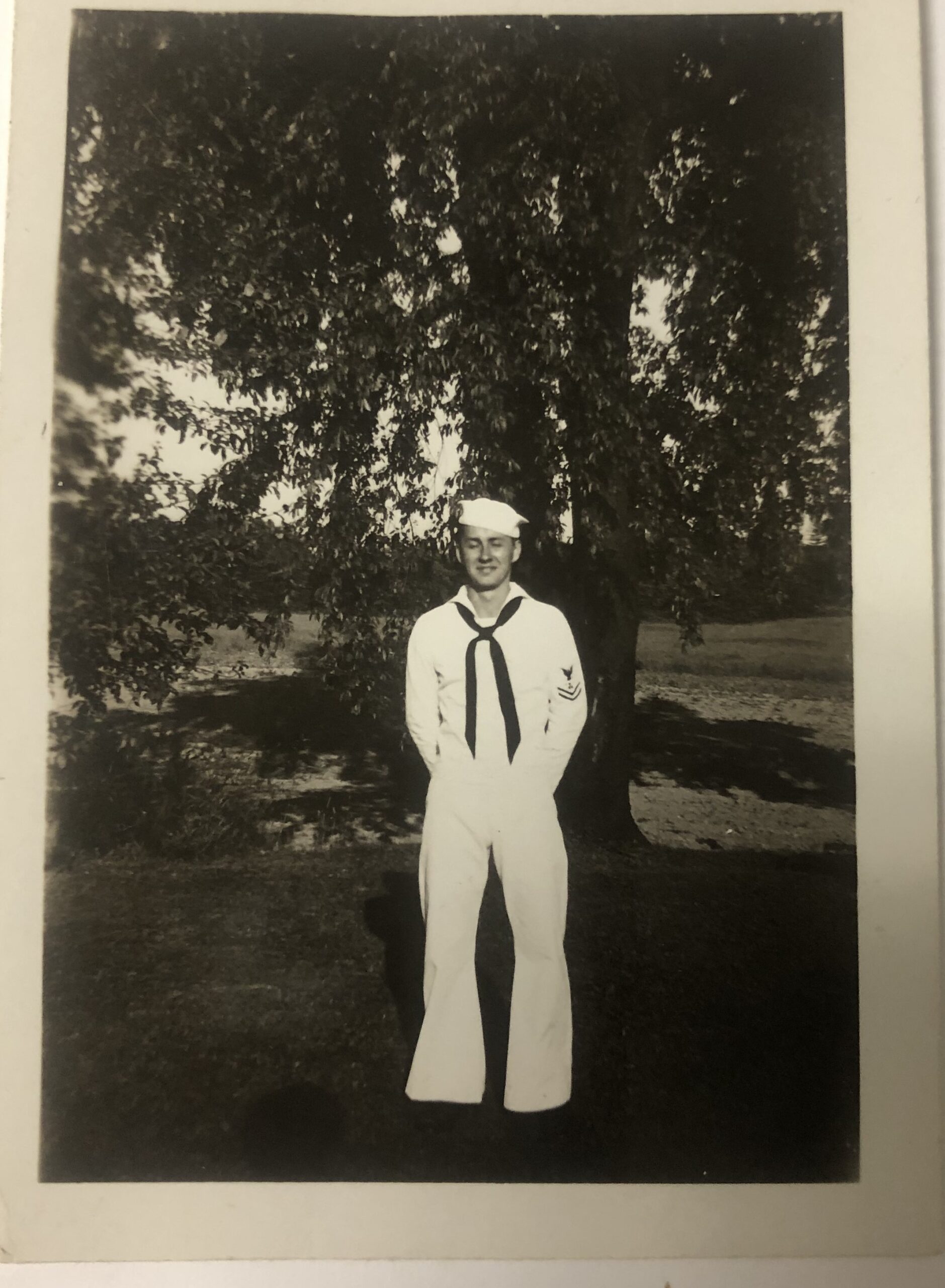 William Becker standing outdoors beneath a large tree.