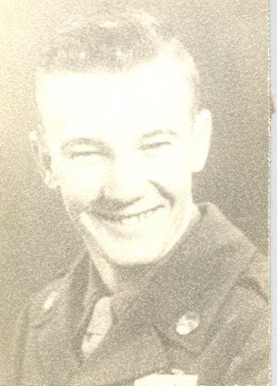 Smiling young serviceman in a faded portrait.