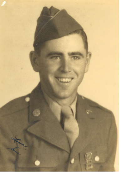 A young man in military uniform smiling at the camera.