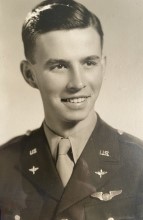 Young serviceman smiling in a formal military portrait.