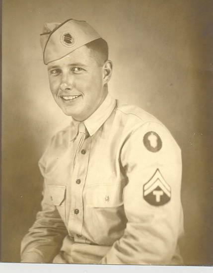 Smiling Paul E. Zernickow wearing a military uniform and garrison cap.