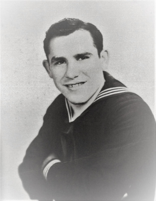 Young sailor wearing a dark U.S. Navy uniform in a formal portrait.