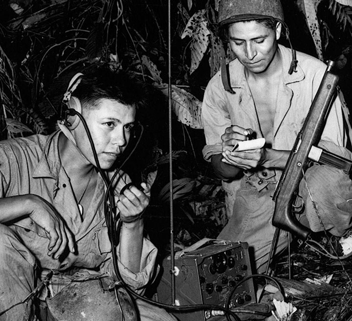 Two soldiers operating field communication equipment during World War II.