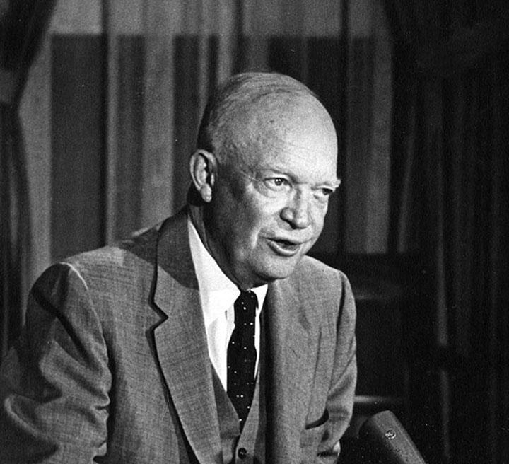 President Dwight D. Eisenhower speaking at a podium.