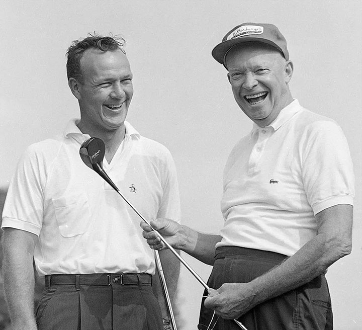 Dwight D. Eisenhower and Arnold Palmer smiling on a golf course.