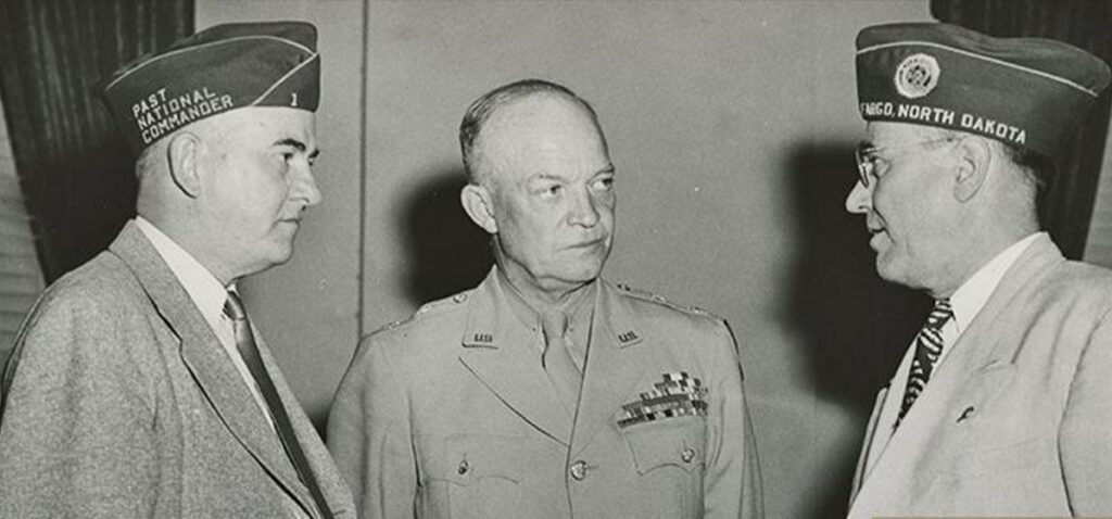 Dwight D. Eisenhower speaking with 2 men after World War II.